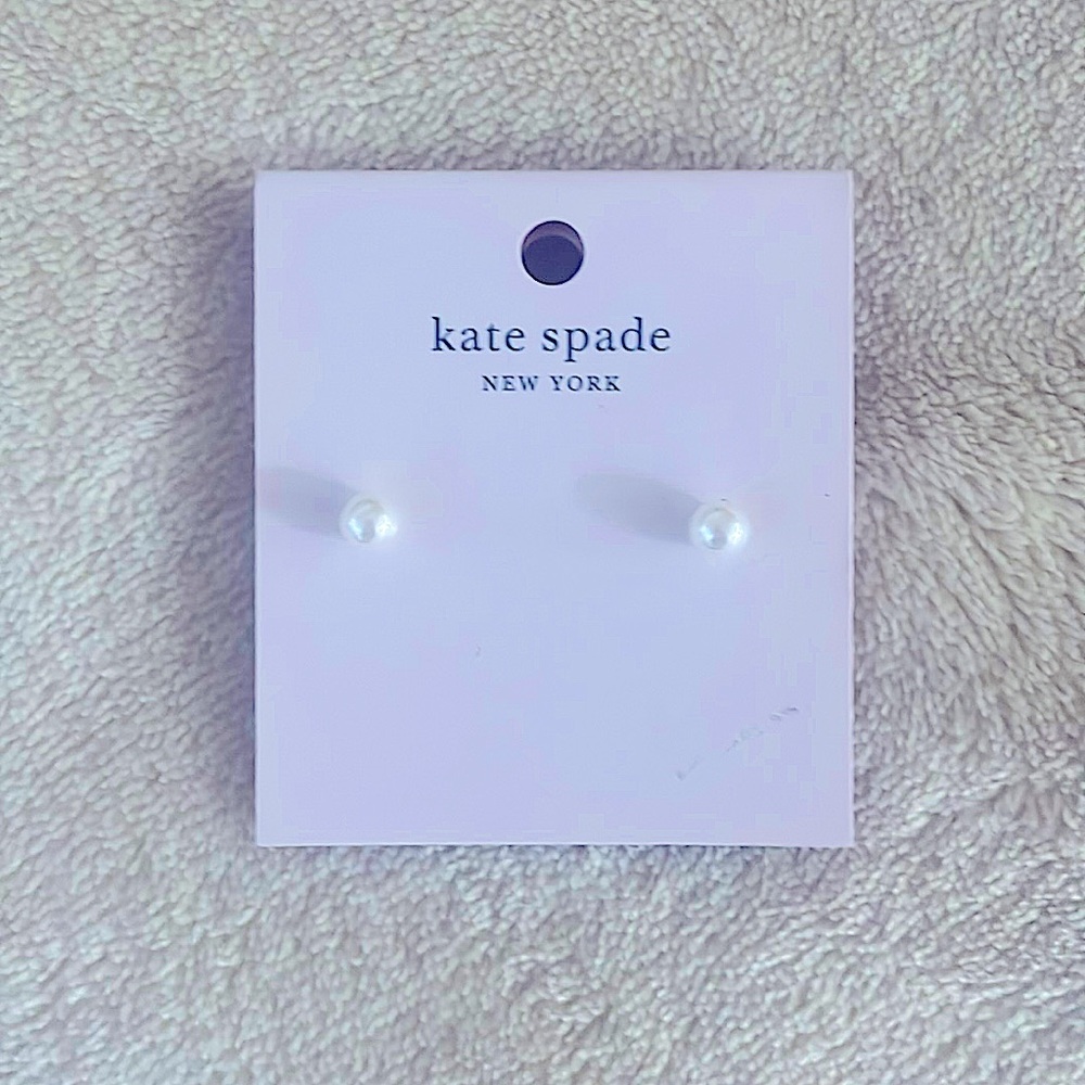 Small realistic, looking pearl style stud earrings.